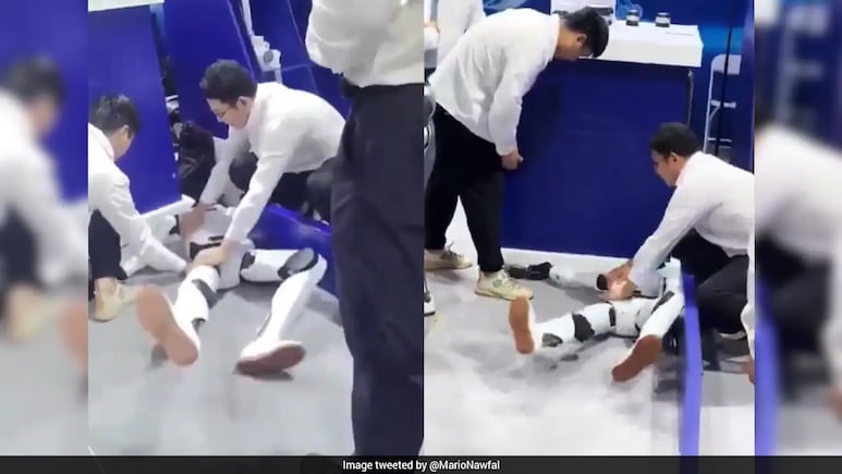 Các kỹ sư tiếp cận và cố gắng giữ robot hình người tại khu vực trình diễn