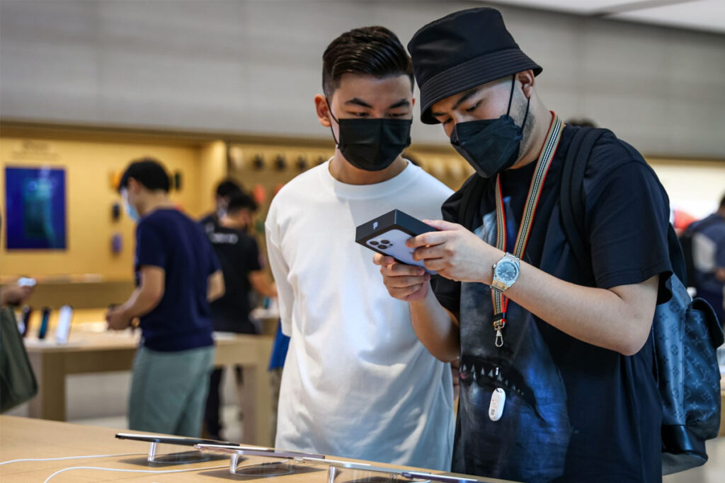 Hai khách hàng xem mẫu smartphone mới tại cửa hàng