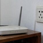 Người dùng rút phích cắm của bộ phát WiFi khỏi ổ điện